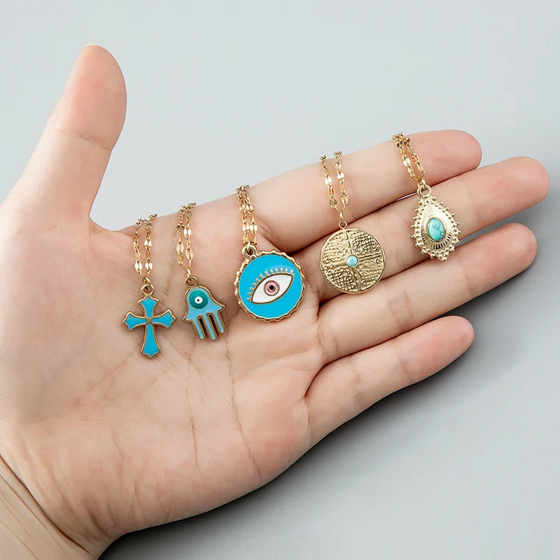 Close detail of blue crystal evil eye cross pendant necklace